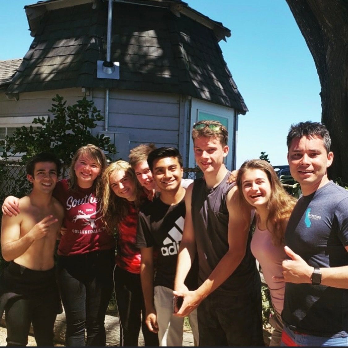 Group of surf students gathered together after a lesson in Santa Cruz